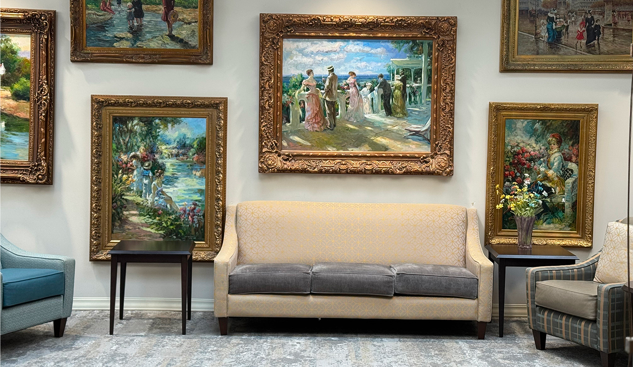 room featuring several colorful paintings hanging on the walls.